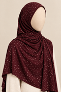 Faceless model wearing a burgundy polka dot jersey hijab