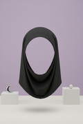 Black hijab on faceless mannequin, lavender background with display blocks
