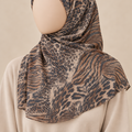 Close-cropped faceless model wearing Savannah Brown printed crinkle chiffon with a short shoulder-length drape
